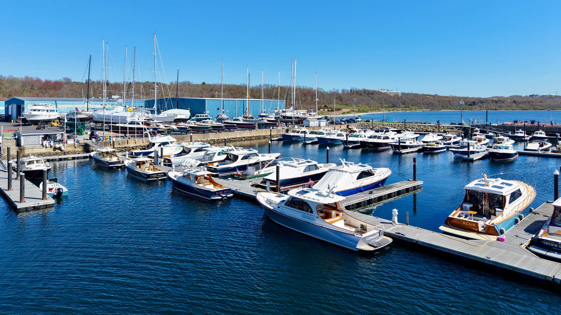 Powerboats and sailboats docked along the Portsmouth marina slips