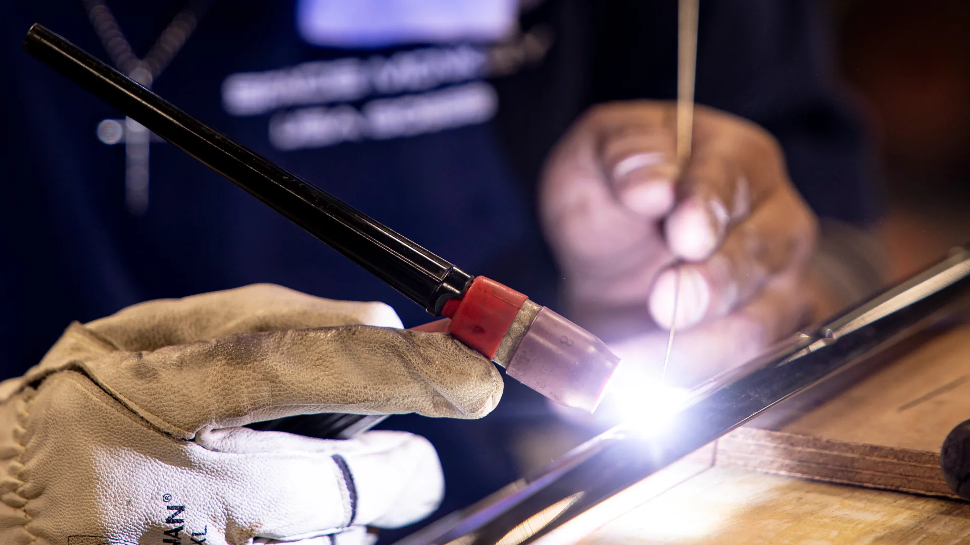 Welder using a torch on metal yacht hardware in Portsmouth