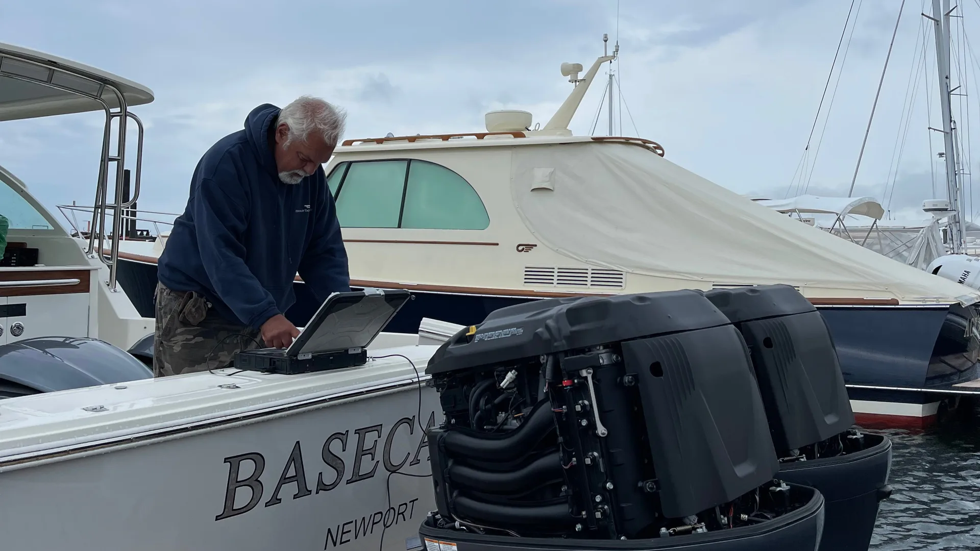 Technician working on the side of an outboard engine at Stamford