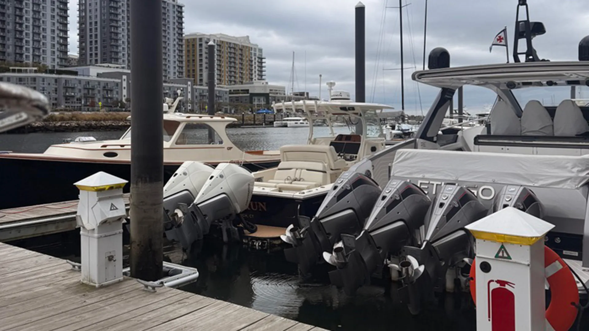 Outboard-powered boats tied up along the Stamford marina docks