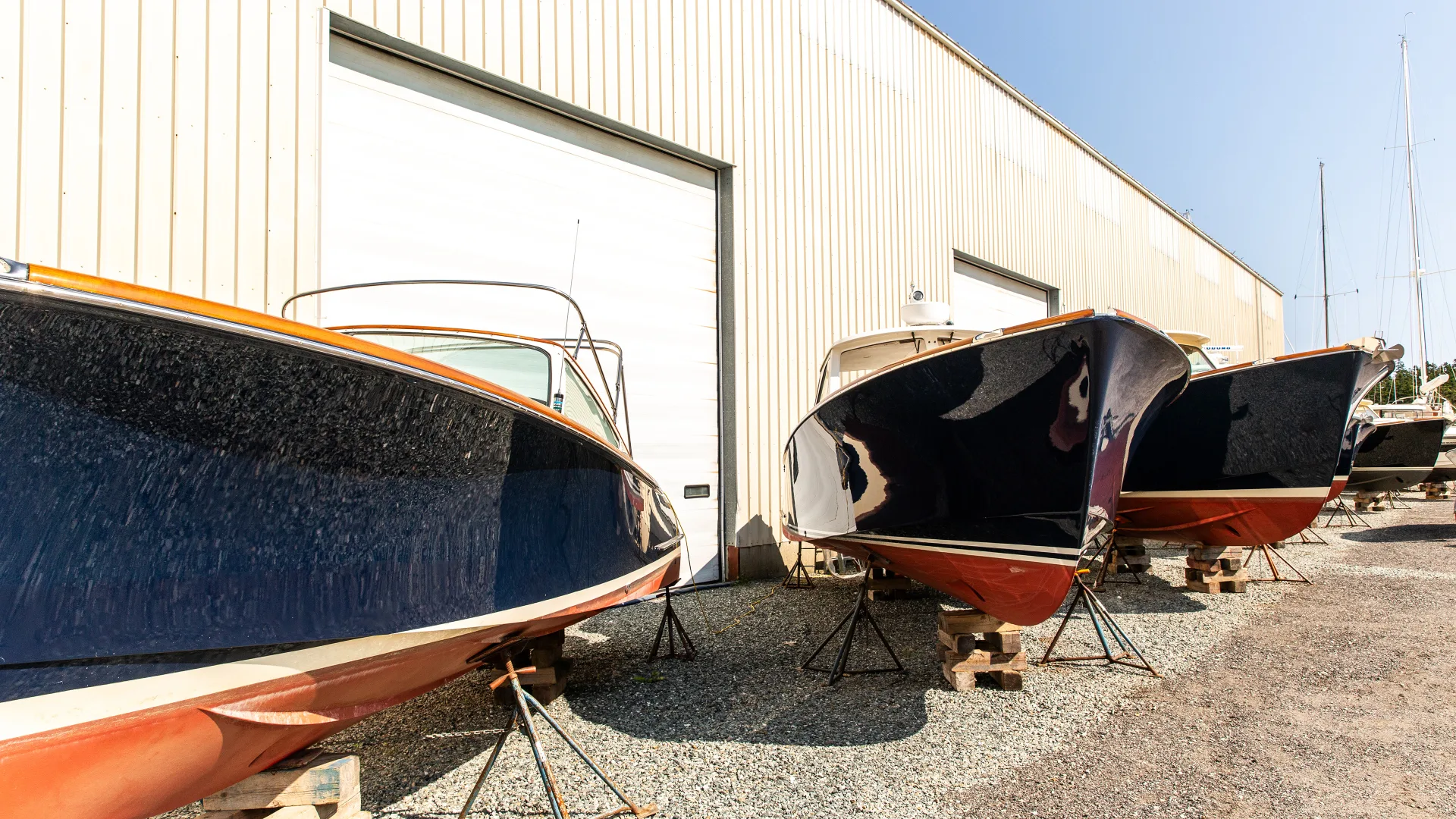 Hinckley powerboats lined up on land outside in Southwest Harbor