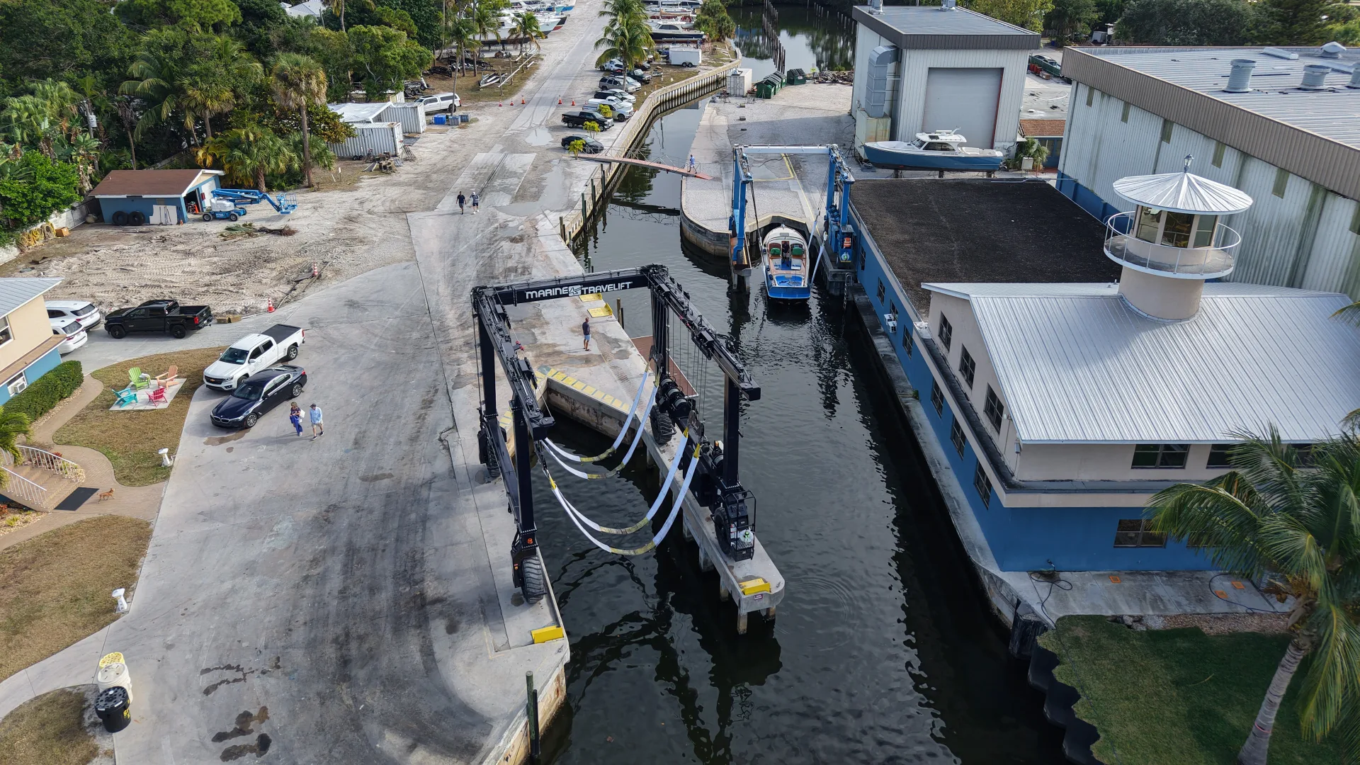 Travelift hauling a boat through the Stuart service yard