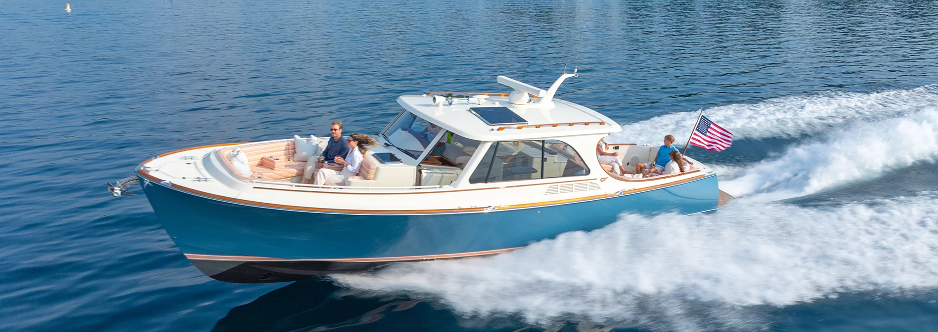 Hinckley Picnic Boat 39 cruising at speed with passengers on open water