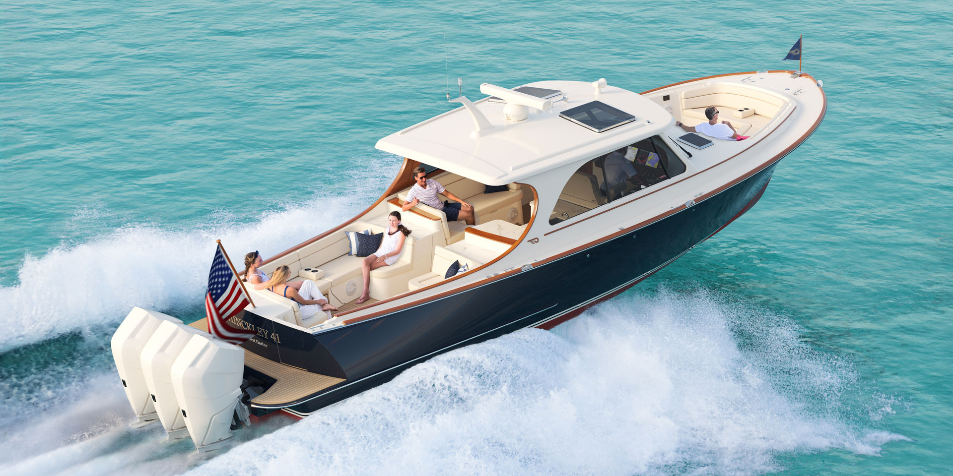 Hinckley 41 luxury motor yacht cruising on turquoise water with outboard engines