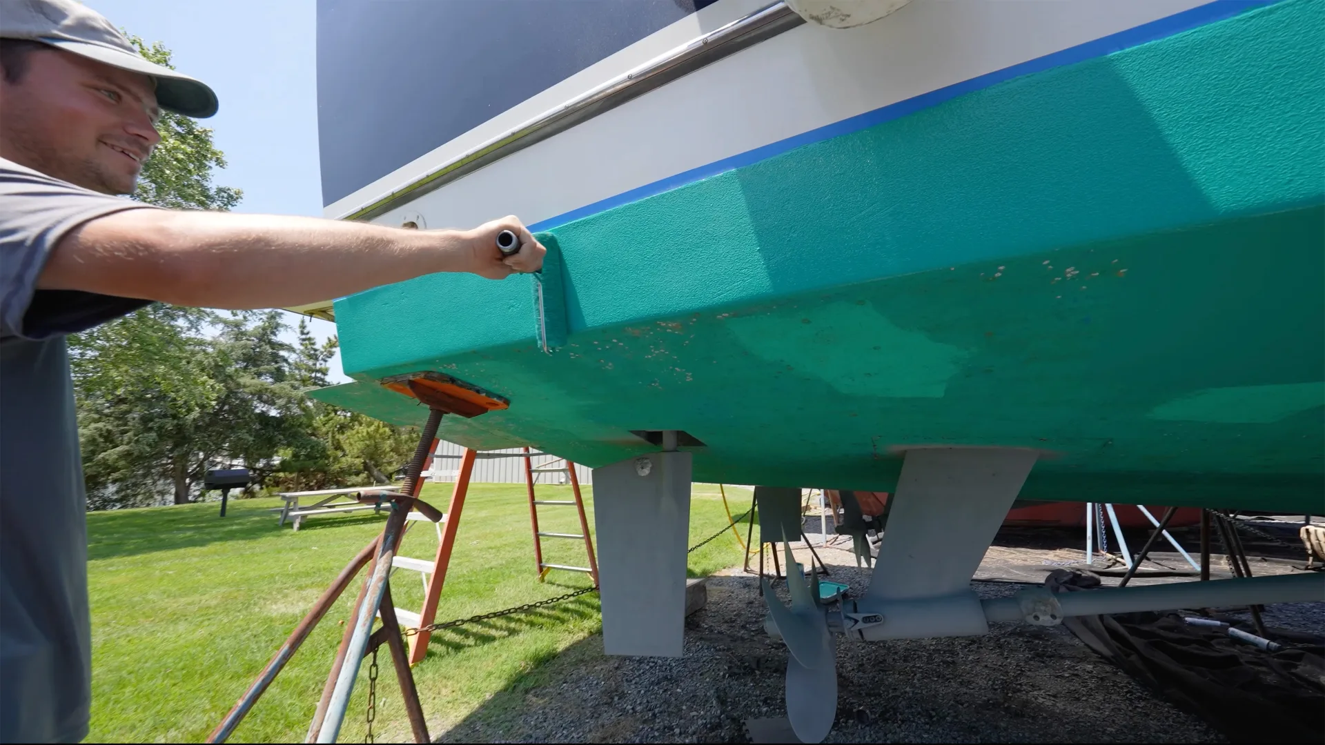Technician inspecting the side of a painted hull in Oxford