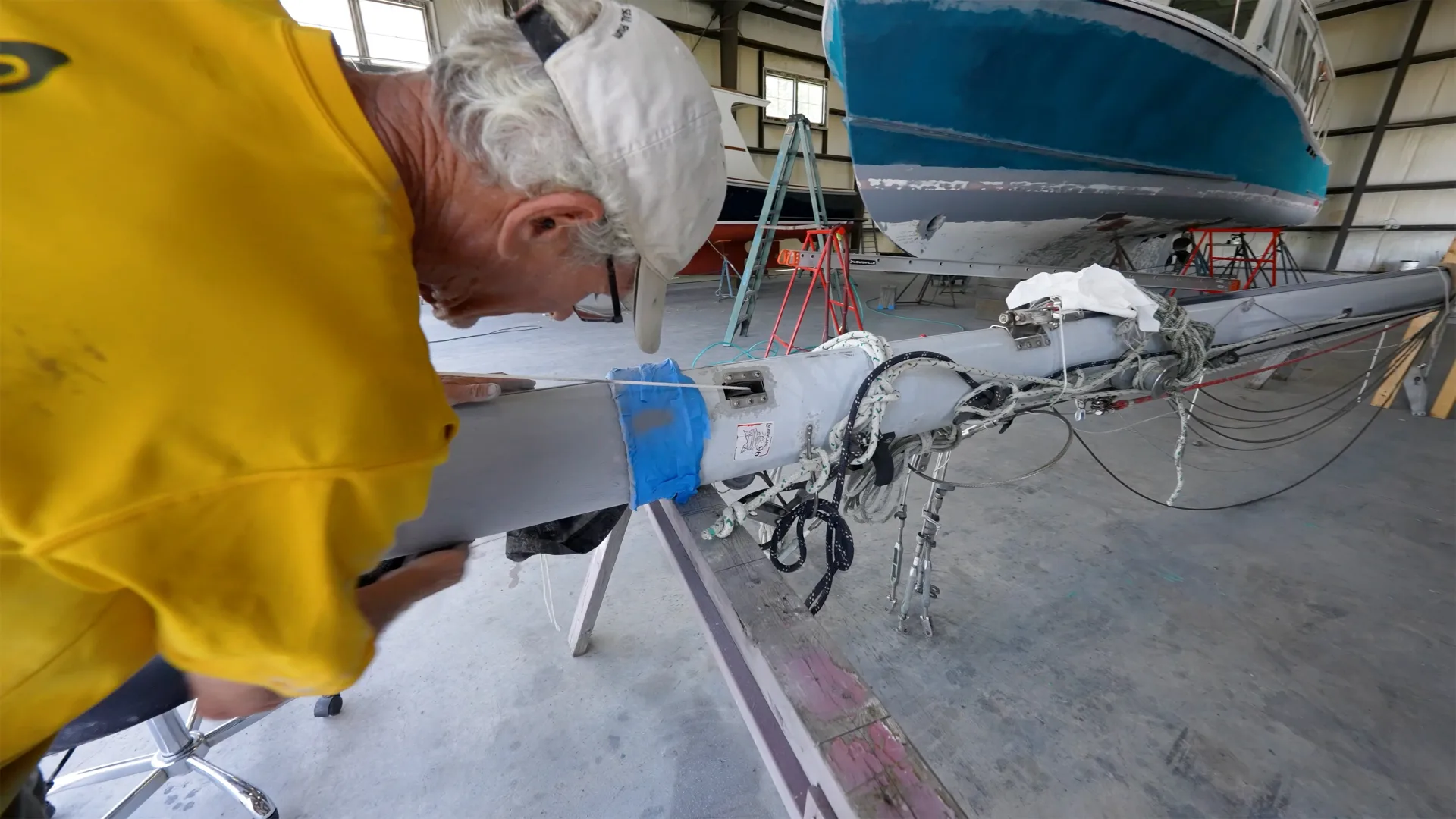 Technician working along a yacht rail above the deck in Oxford
