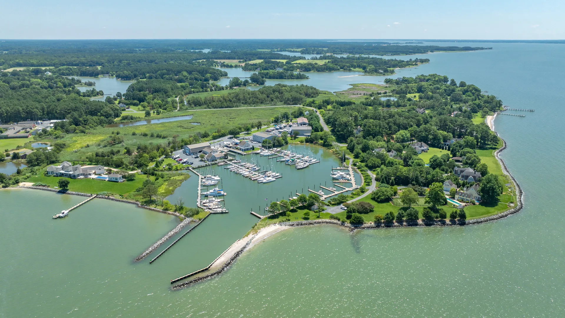 Aerial view of Bachelor Point marina docks and shoreline in Oxford