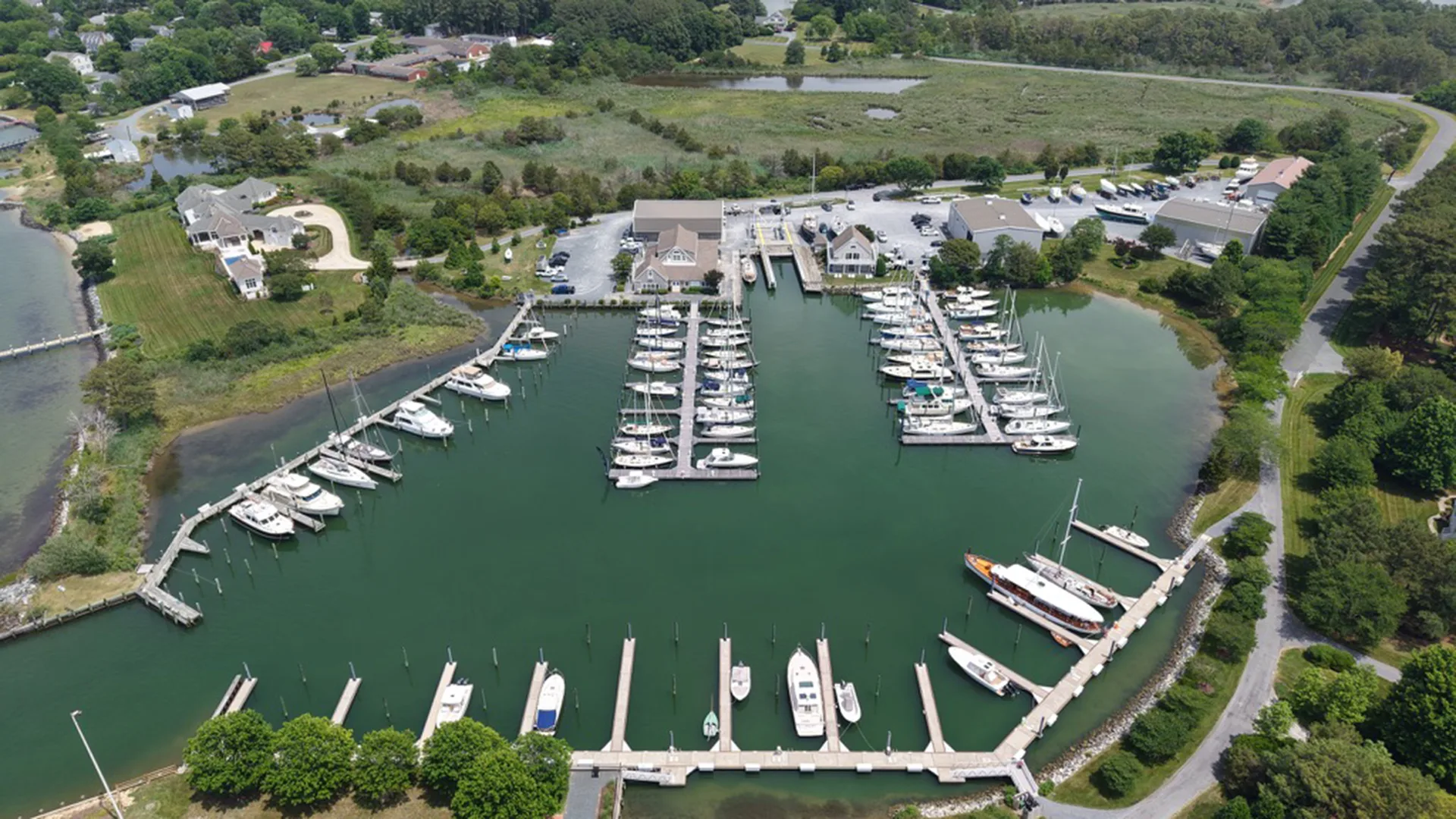 Wide aerial view of boats, slips, and shoreline in the Oxford marina basin