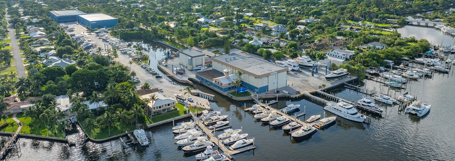 Aerial view of Hinckley Yacht Services’ Stuart, Florida marina and service facility with boats docked along the waterfront.