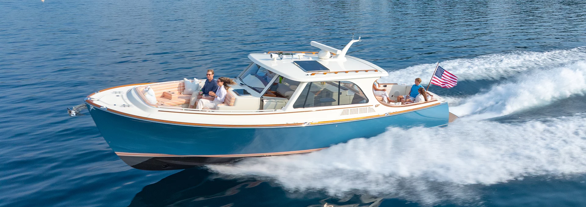 Hinckley Picnic Boat 39 cruising at speed with passengers on open water