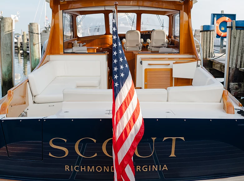 Hinckley yacht stern and cockpit craftsmanship docked at marina showcasing classic woodwork