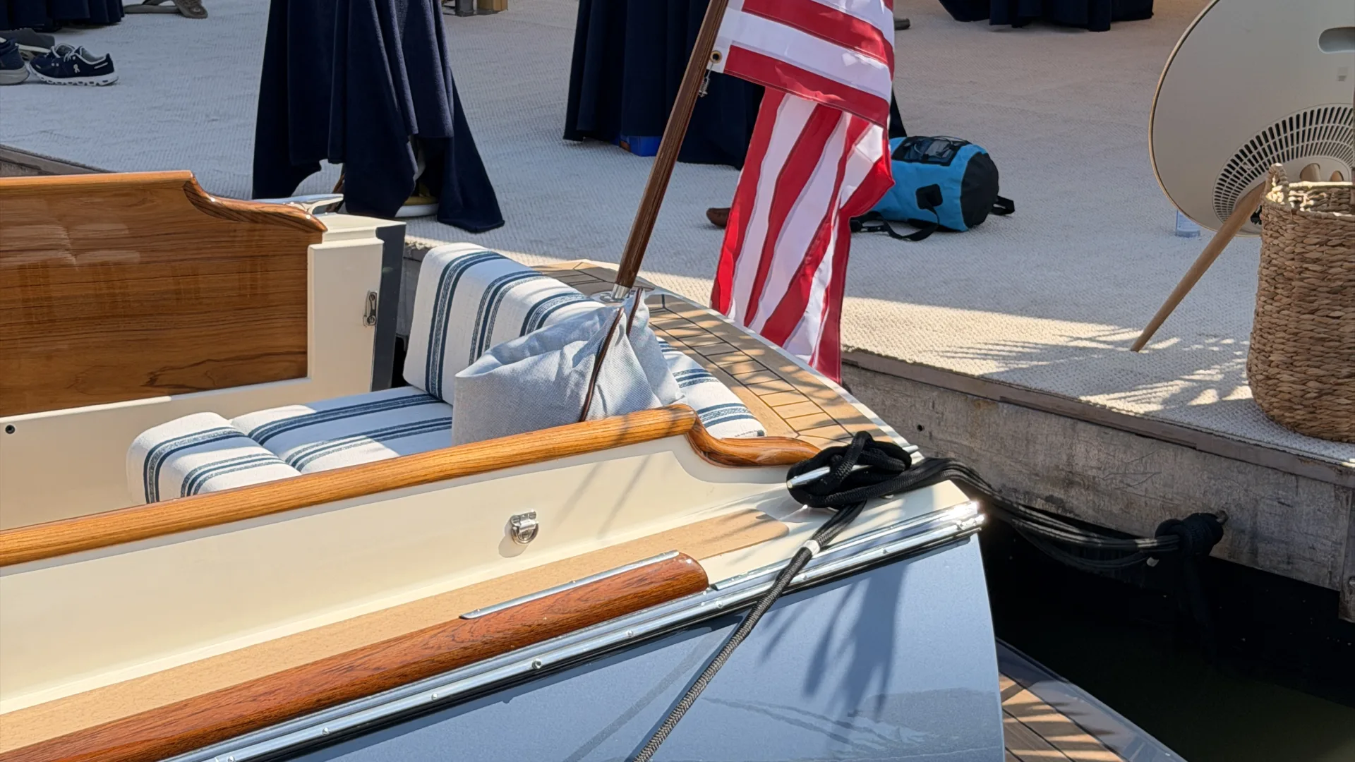 Hinckley Picnic Boat stern docked at marina with American flag during boat show event