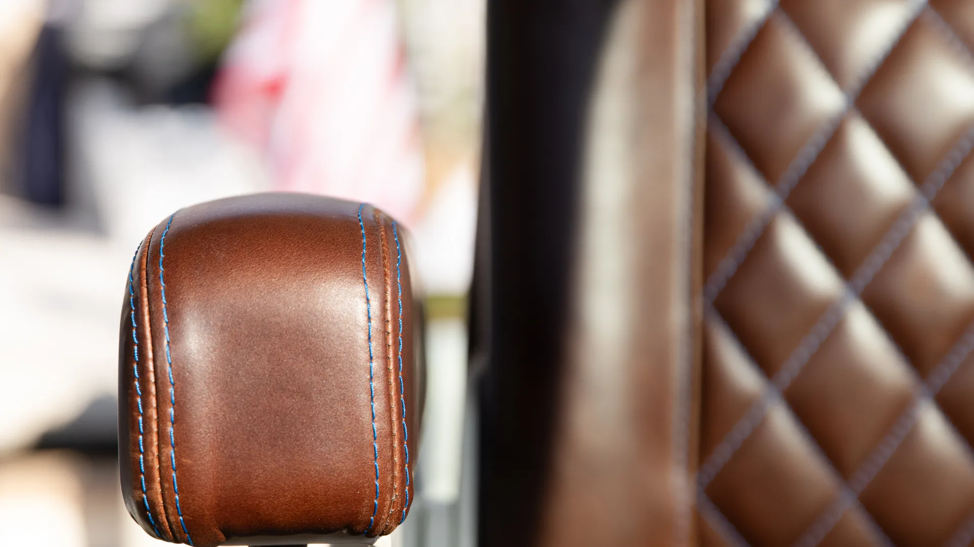 Close-up of Hinckley yacht leather helm seat with quilted stitching and armrest detail