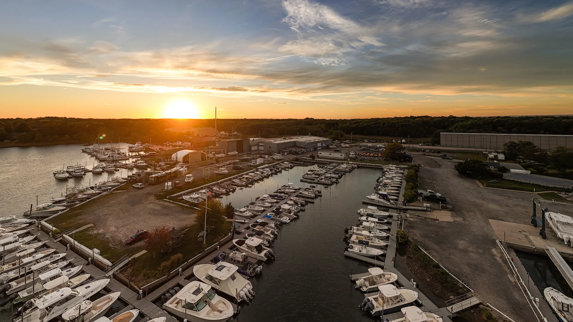 Sunset over docked boats at Port of Egypt marina in Southold