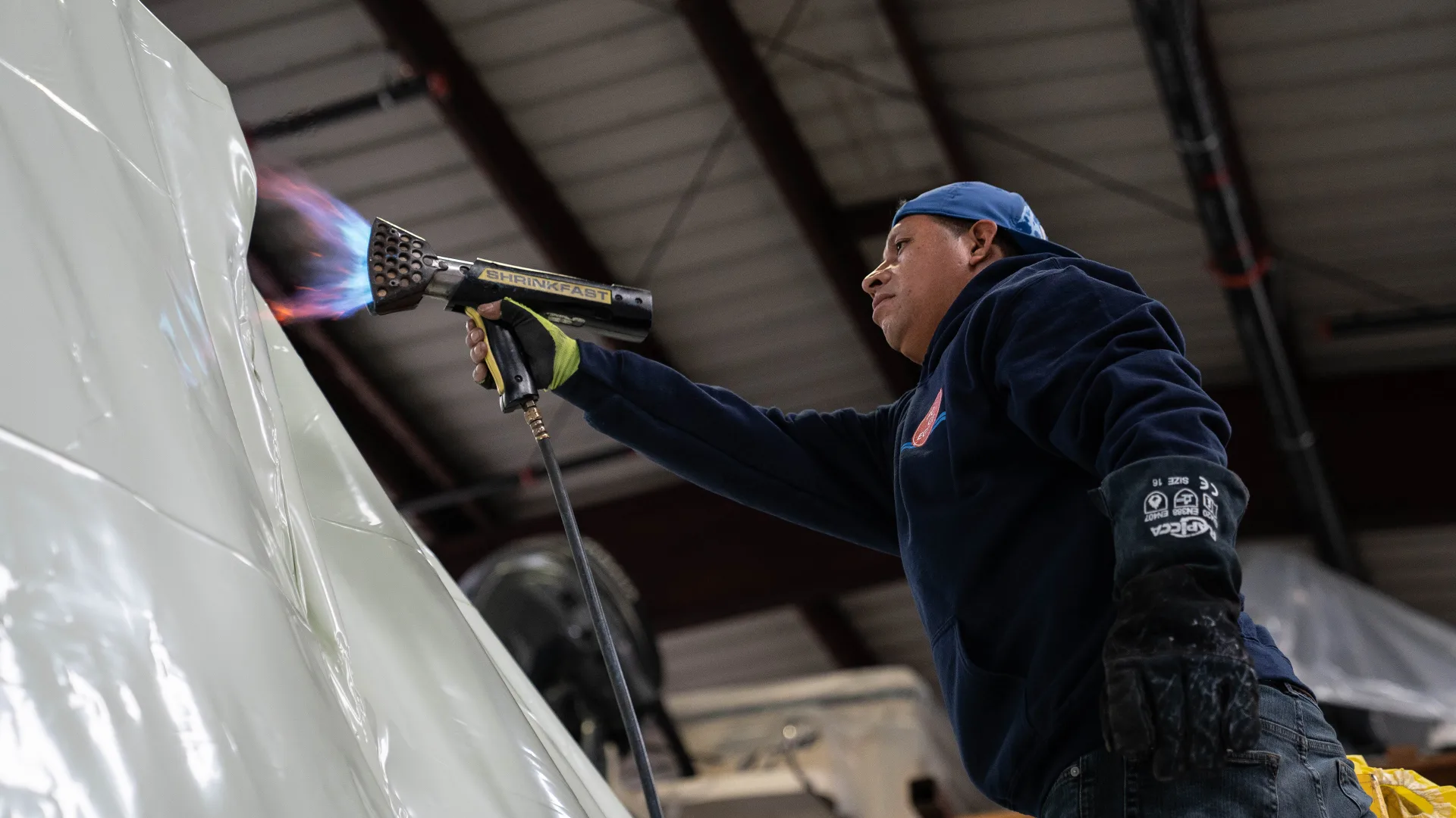 Technician servicing the side of an outboard engine in Southold