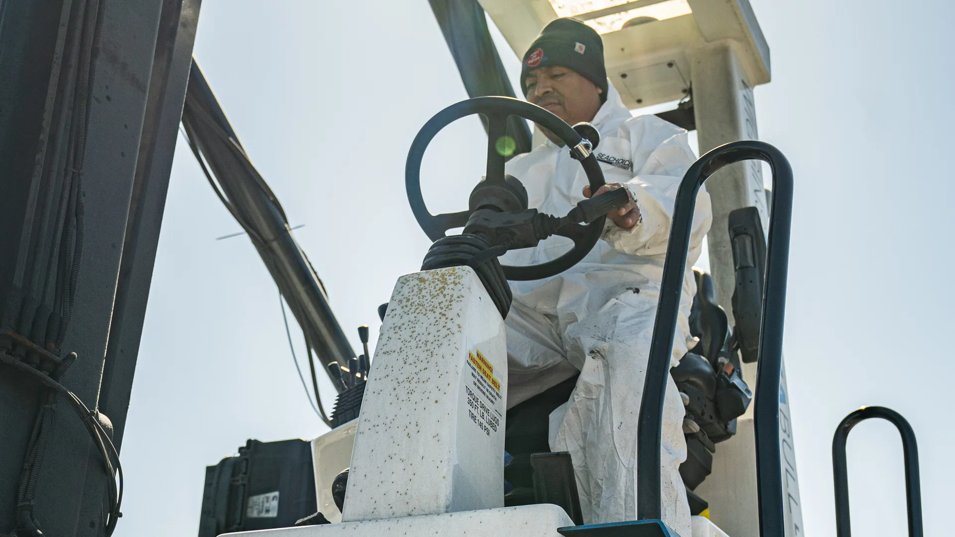 Forklift operator moving boats through the Southold yard