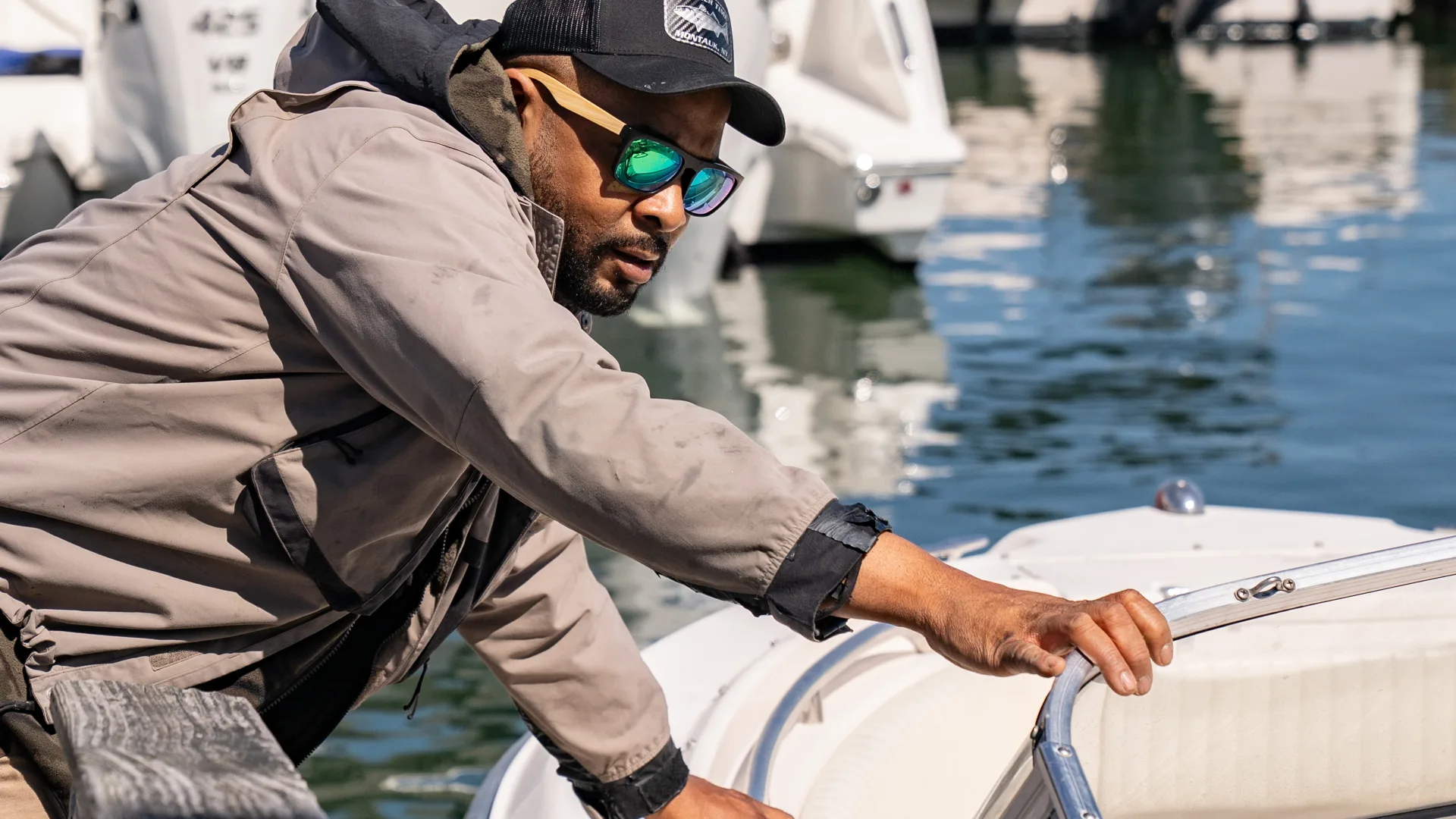 Dockhand handling a boat line beside the dock in Southold