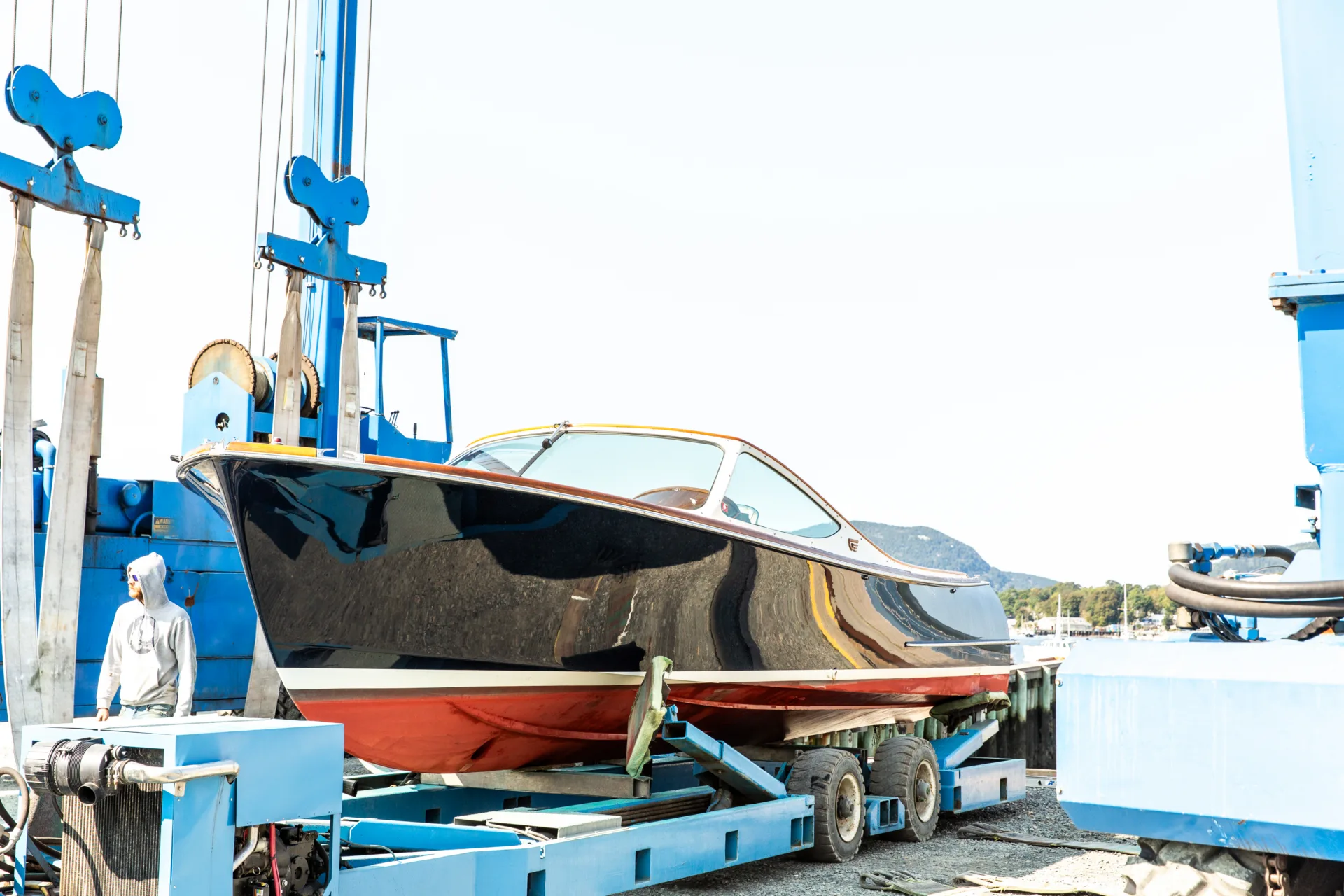 Powerboat suspended in the Northeast Harbor travelift slings