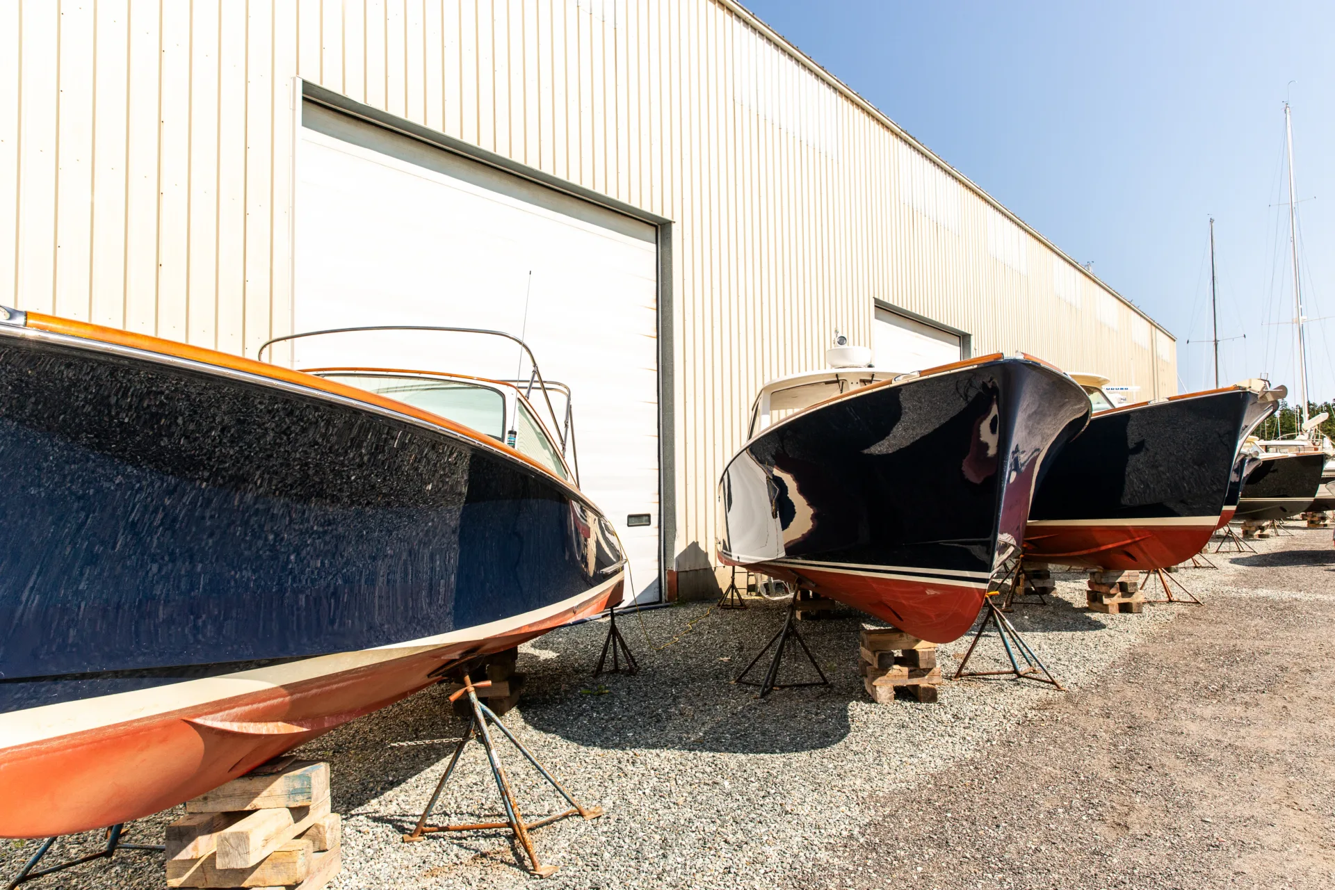 Hinckley powerboats lined up on land outside at Northeast Harbor