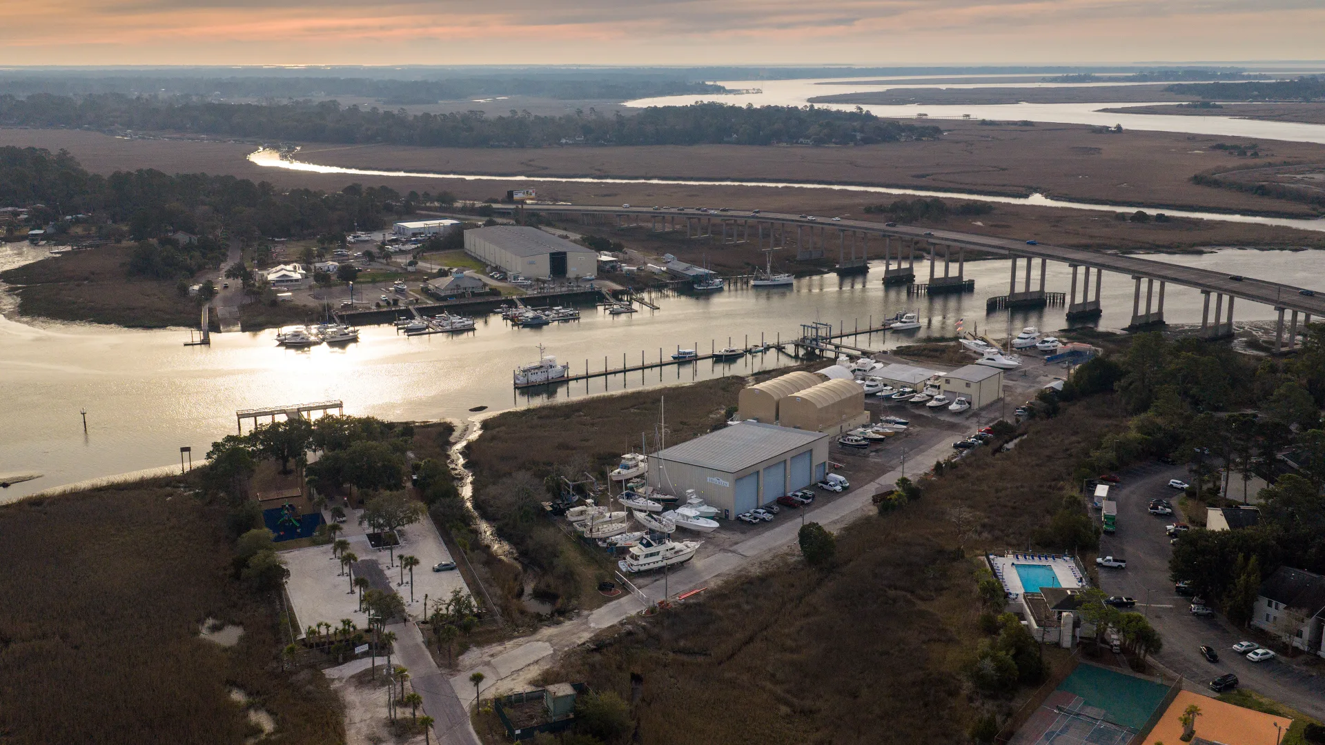 Savannah service yard, docked boats, and river at sunset