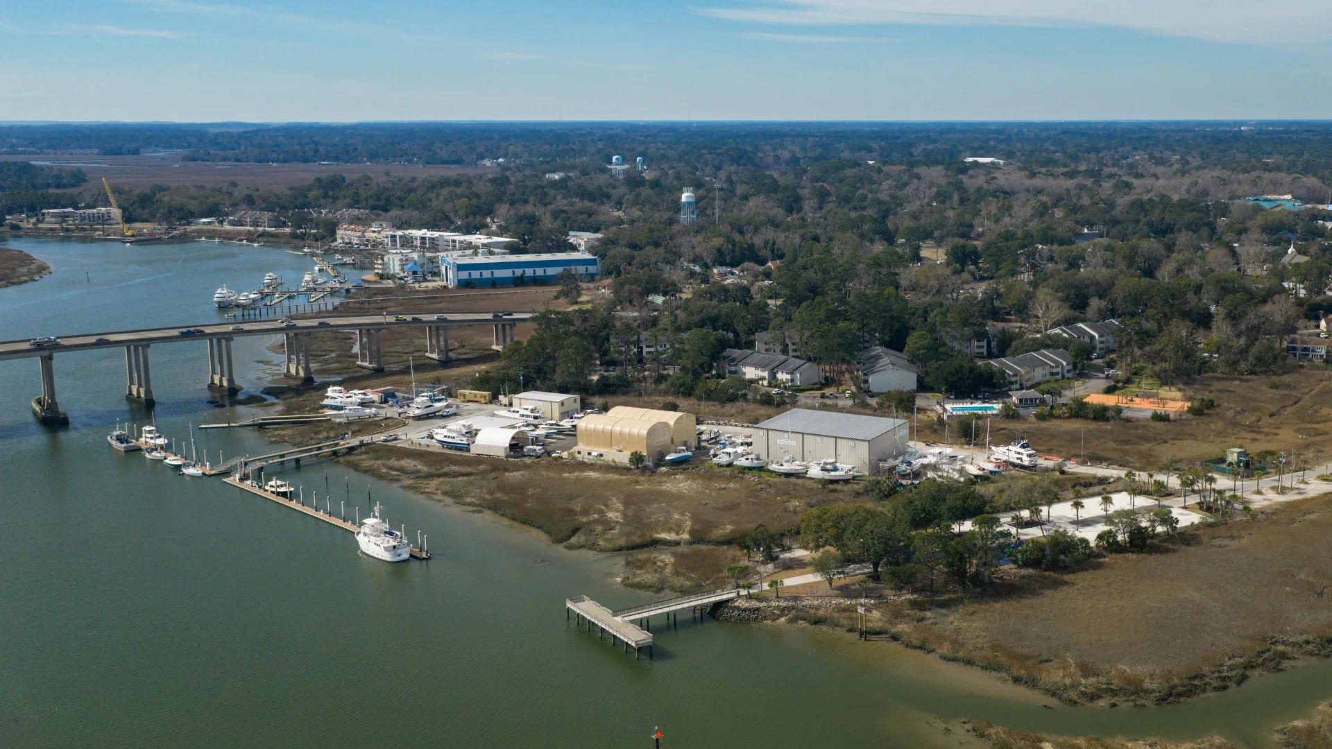 Wide aerial view of Savannah service buildings, boats, and riverfront docks
