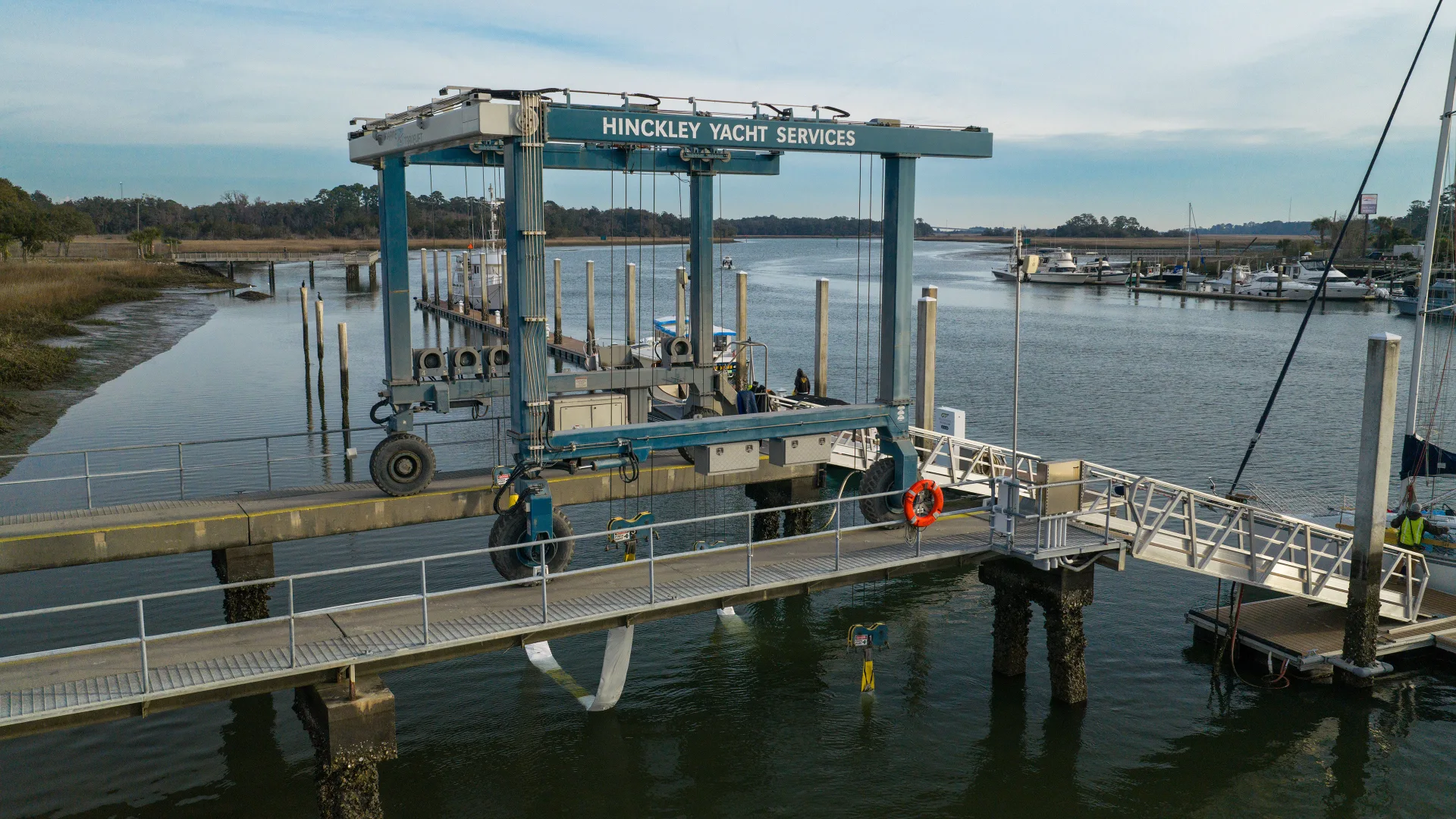 Savannah travelift positioned over a yacht at the riverfront dock