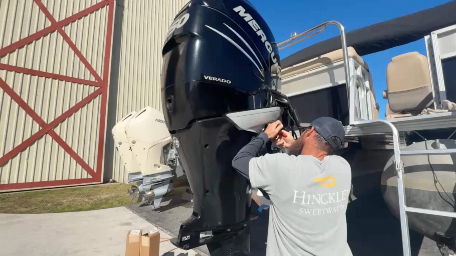 Technician working beside twin outboard engines at Fort Myers