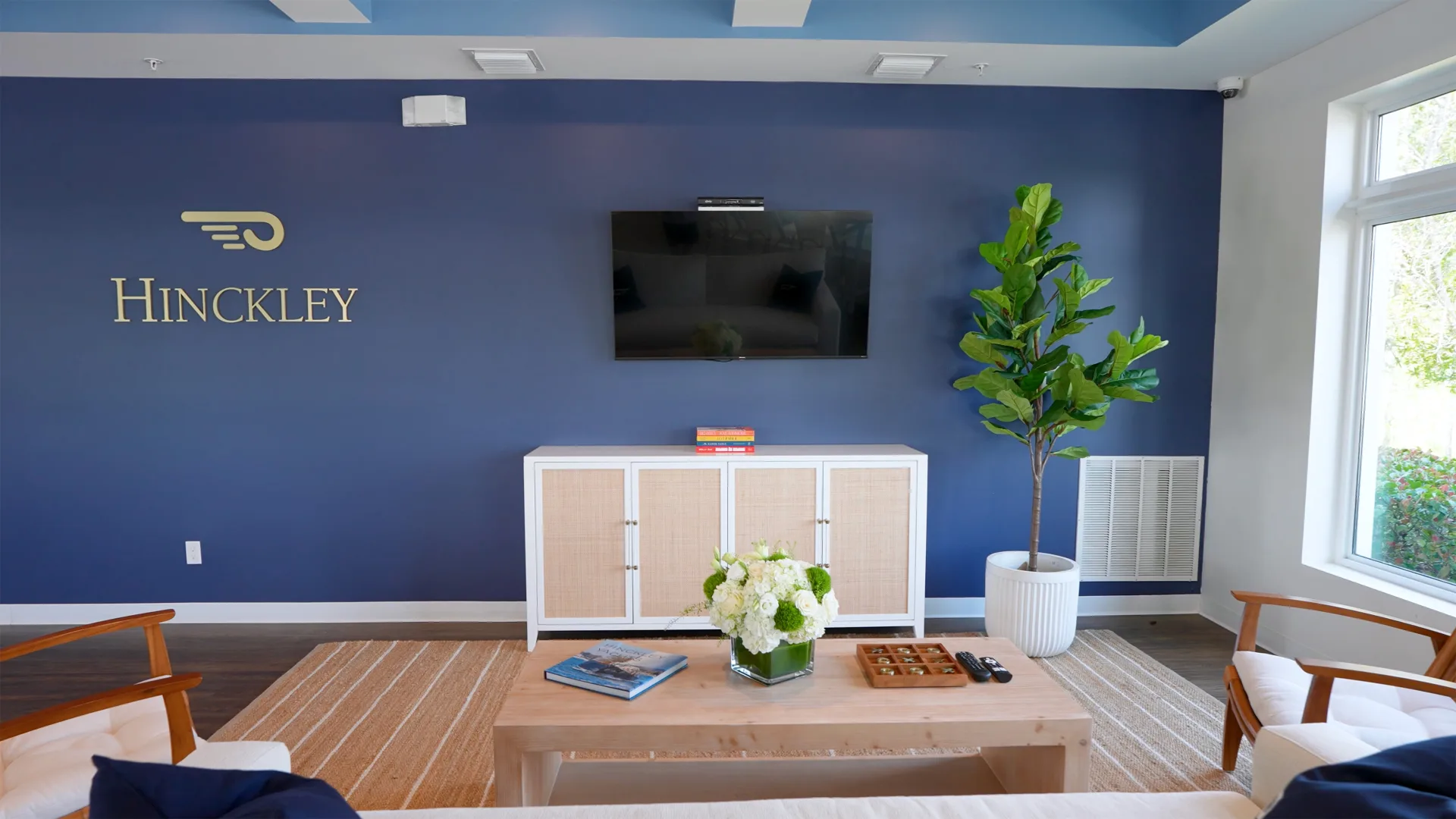 Fort Myers owner lounge with seating, tables, and Hinckley wall logo