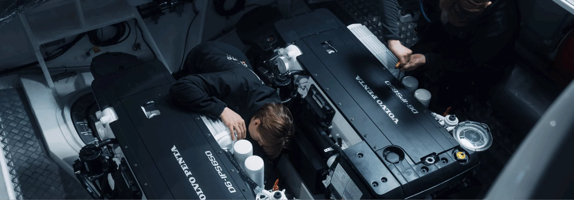 Technicians working inside a yacht engine room